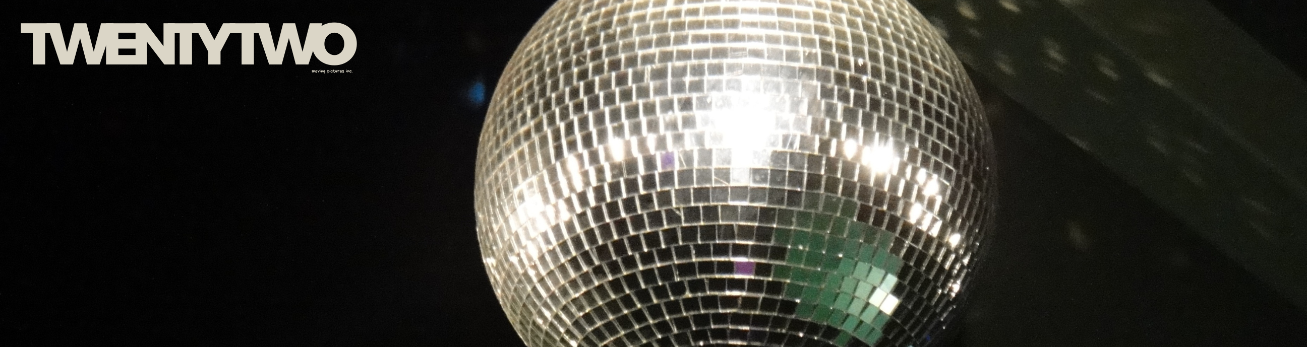 TwentyTwo beside a close-up disco ball